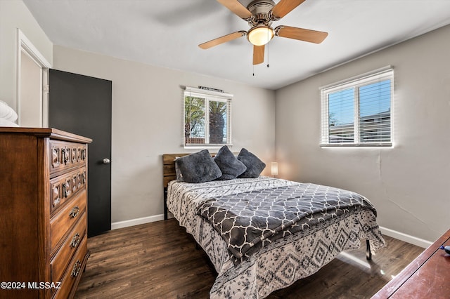 bedroom with a ceiling fan, baseboards, and wood finished floors