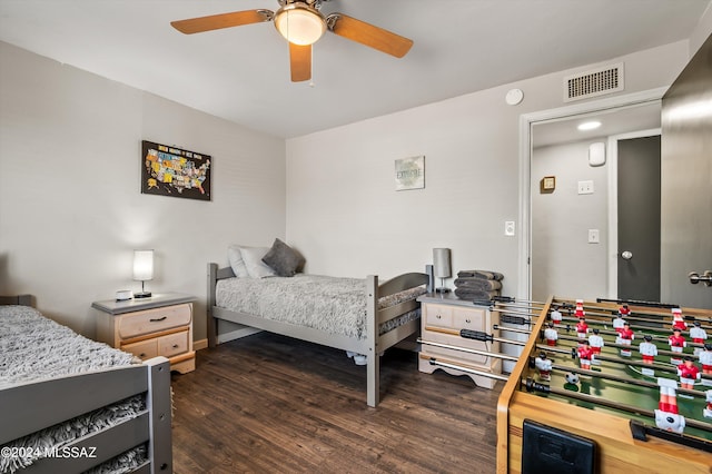 bedroom with visible vents, baseboards, dark wood-type flooring, and a ceiling fan