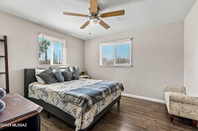 bedroom featuring a ceiling fan, multiple windows, wood finished floors, and baseboards