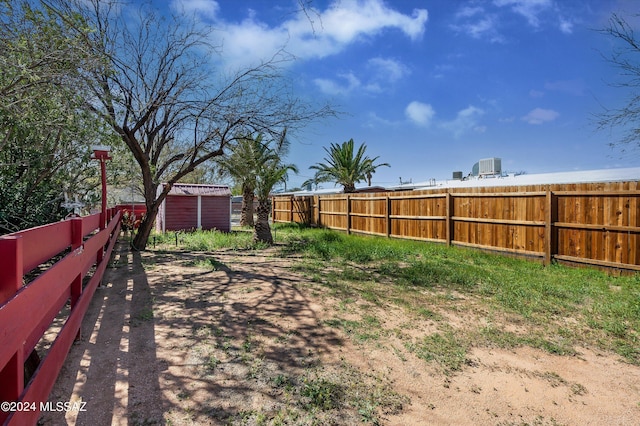 view of yard with an outdoor structure and a fenced backyard