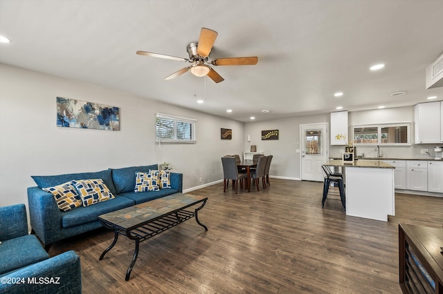 living area with recessed lighting, baseboards, a ceiling fan, and dark wood-style flooring