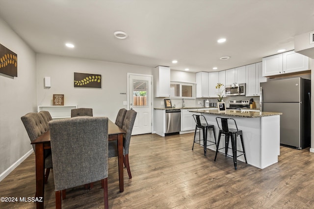 dining room with visible vents, recessed lighting, dark wood-style flooring, and baseboards