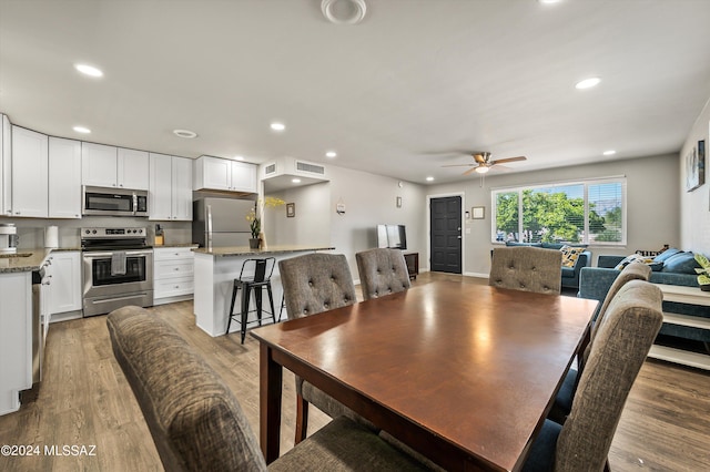 dining space with light wood-type flooring, visible vents, recessed lighting, and a ceiling fan