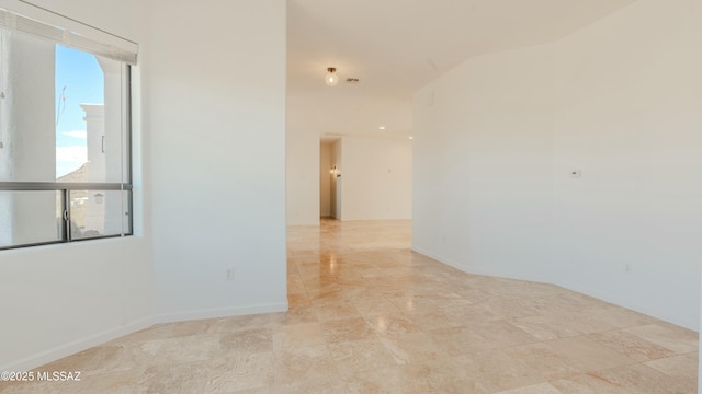 spare room featuring baseboards