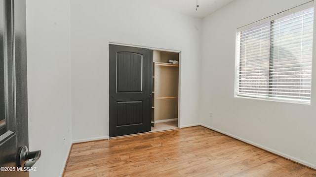 empty room featuring wood finished floors and baseboards