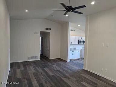 unfurnished room with visible vents, dark wood-type flooring, a ceiling fan, recessed lighting, and lofted ceiling