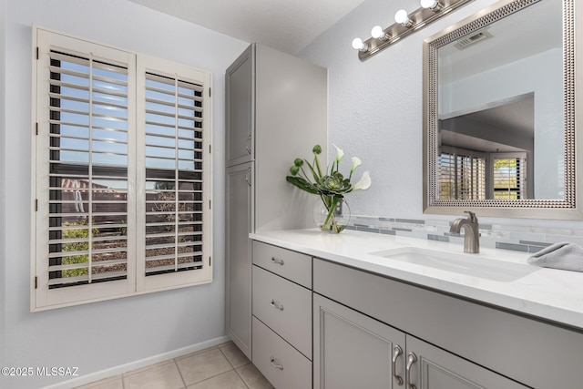 bathroom featuring a healthy amount of sunlight, vanity, and tile patterned flooring