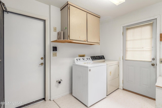laundry room with cabinet space, separate washer and dryer, and baseboards