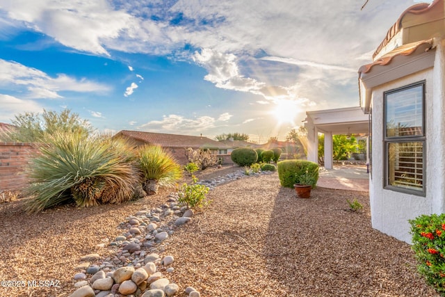 view of yard featuring fence and a patio area