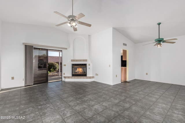 unfurnished living room featuring visible vents, a ceiling fan, high vaulted ceiling, and a fireplace