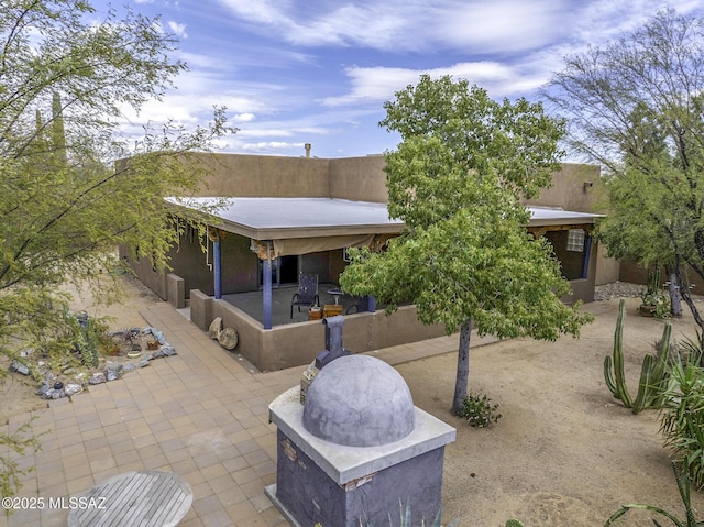 exterior space featuring stucco siding and a patio