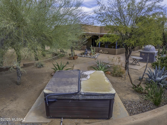 view of yard featuring a patio and a hot tub