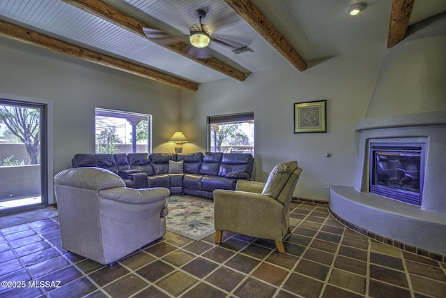 living area with beam ceiling, visible vents, a fireplace, and a ceiling fan