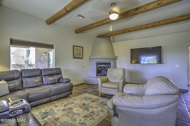 tiled living room with beam ceiling, visible vents, a fireplace, and baseboards