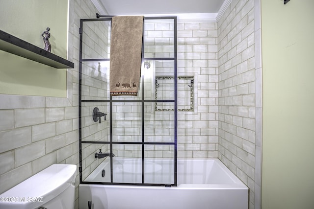 full bath featuring bath / shower combo with glass door, tile walls, and toilet