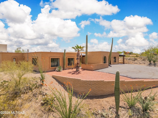 rear view of house with stucco siding