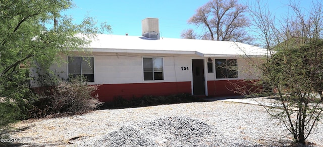 single story home featuring a chimney