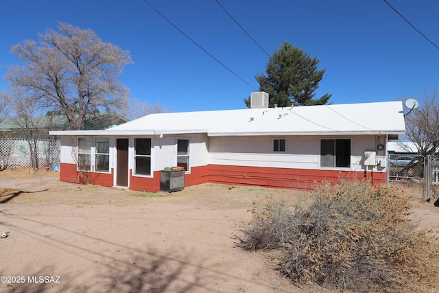 rear view of house featuring fence and cooling unit