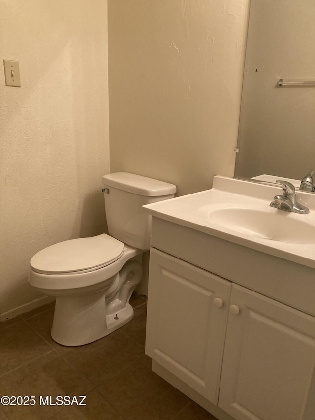 bathroom with tile patterned floors, toilet, and vanity