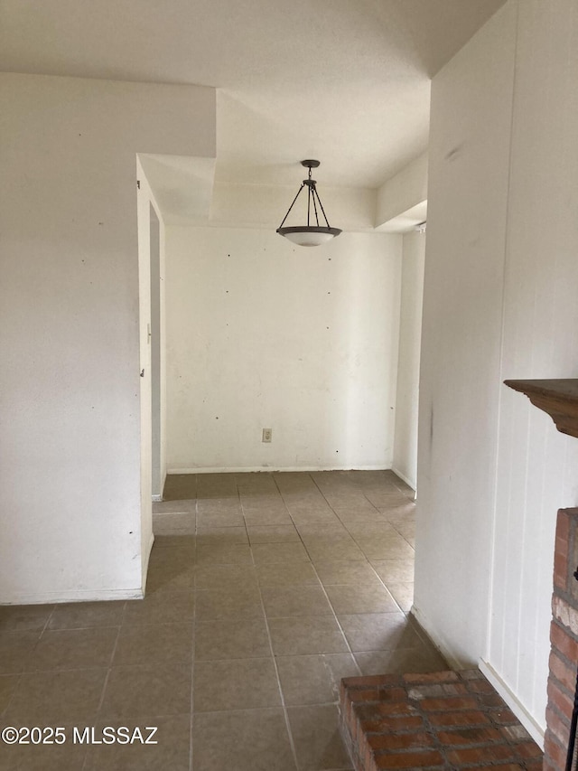 empty room featuring dark tile patterned floors