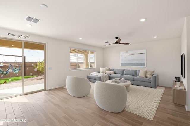 living room with visible vents, recessed lighting, ceiling fan, and wood finished floors