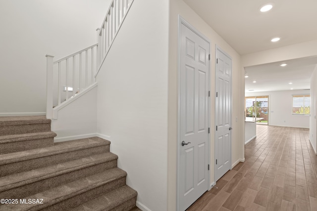 stairs featuring recessed lighting, baseboards, and wood finished floors