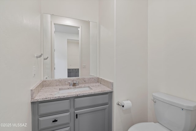 bathroom featuring toilet and vanity