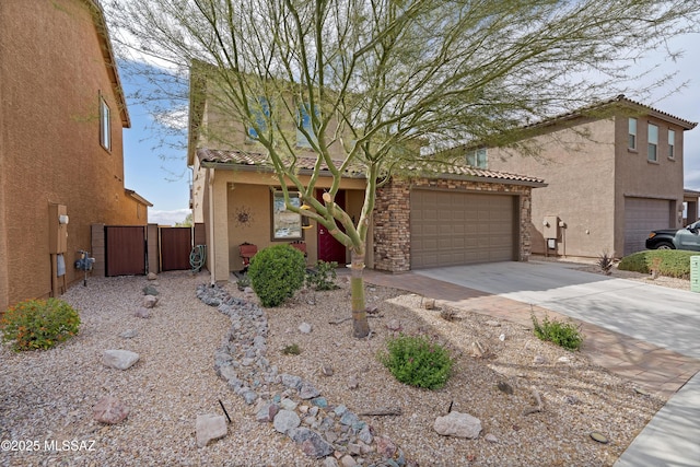 view of front of home with stucco siding, driveway, fence, a garage, and a tiled roof