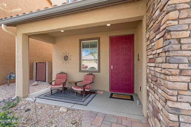 view of exterior entry with stucco siding