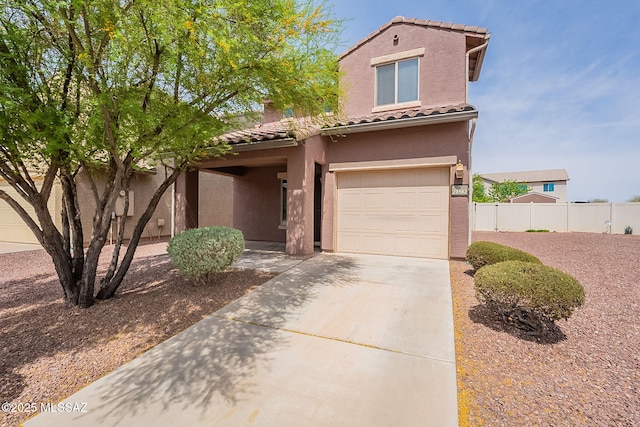 view of front of house with a tile roof, concrete driveway, stucco siding, fence, and an attached garage