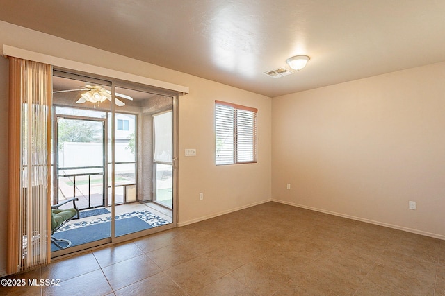 interior space with baseboards, visible vents, and a ceiling fan