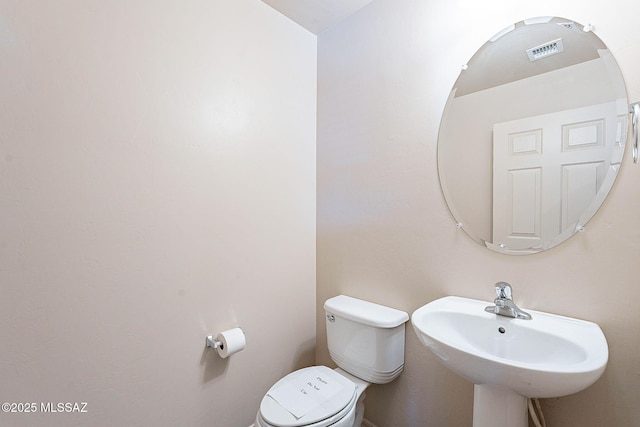 bathroom with toilet and a sink