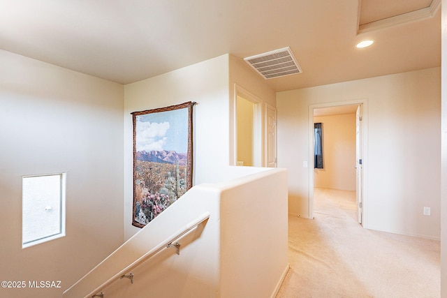 corridor featuring light carpet, visible vents, an upstairs landing, and recessed lighting