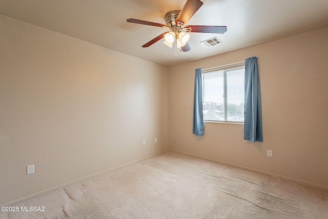carpeted spare room with a ceiling fan, baseboards, and visible vents