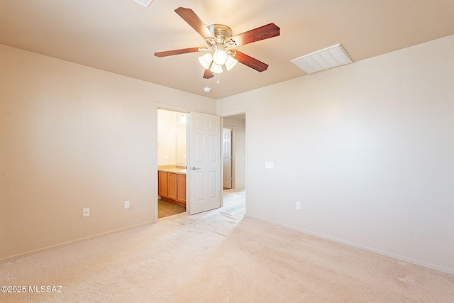 empty room with light colored carpet, visible vents, ceiling fan, and baseboards