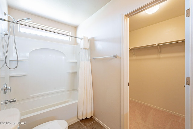 full bath featuring tile patterned floors, a walk in closet, toilet, and shower / bath combination with curtain