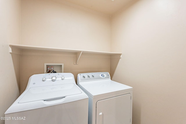 washroom featuring independent washer and dryer and laundry area