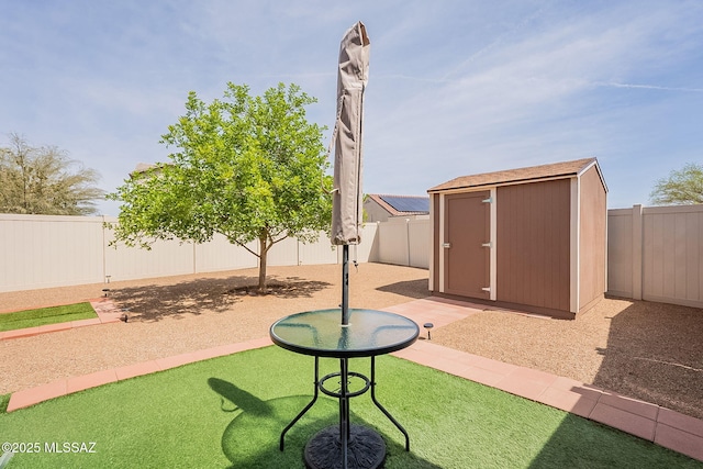 view of patio / terrace featuring a fenced backyard, an outdoor structure, and a storage shed