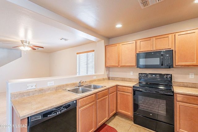 kitchen featuring a sink, visible vents, black appliances, and light brown cabinets