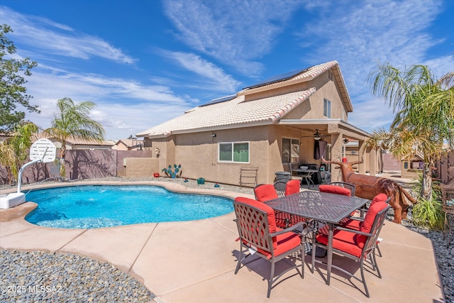 view of pool with a patio area, outdoor dining space, a fenced in pool, and a fenced backyard