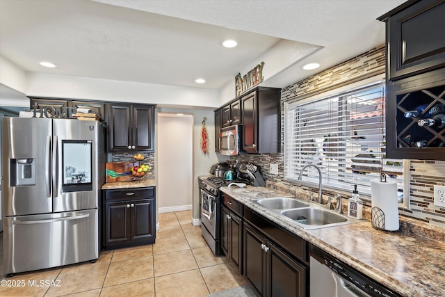 kitchen featuring a sink, backsplash, recessed lighting, stainless steel appliances, and light tile patterned flooring