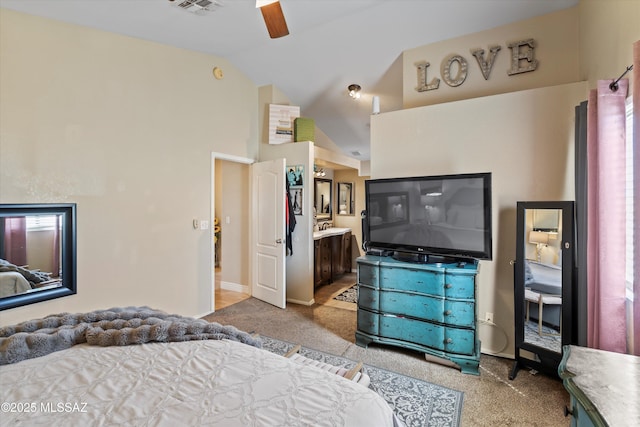 carpeted bedroom with ceiling fan, visible vents, lofted ceiling, and ensuite bath