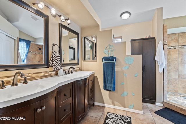 full bath featuring visible vents, tiled shower, tasteful backsplash, and a sink