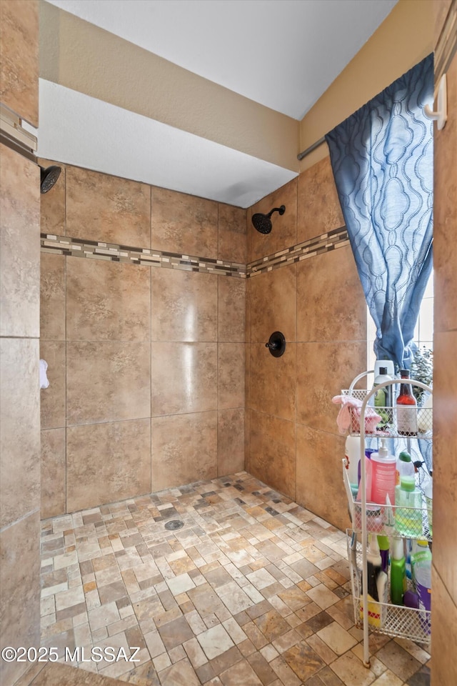 bathroom with tiled shower