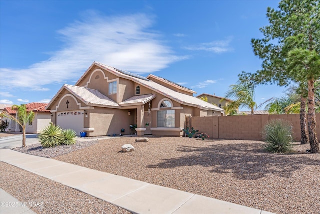 view of front of home with stucco siding, fence, concrete driveway, a garage, and solar panels