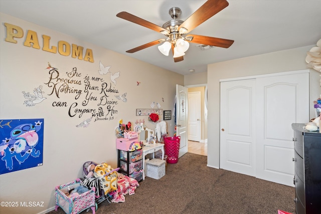 recreation room with visible vents, carpet flooring, and ceiling fan