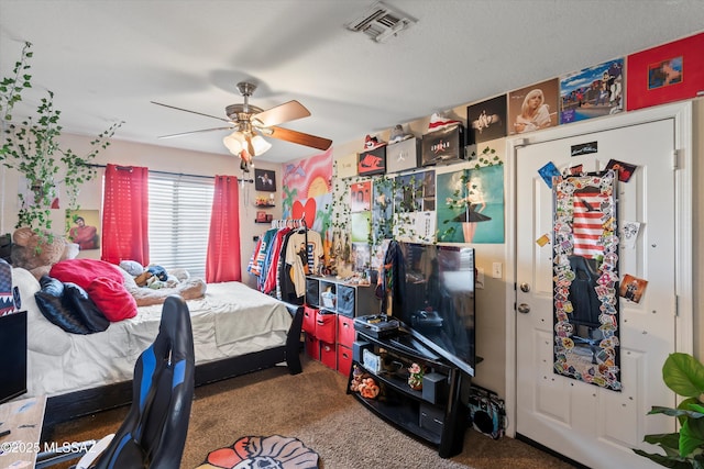 carpeted bedroom with visible vents and ceiling fan