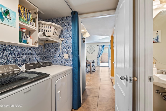 clothes washing area with light tile patterned flooring, laundry area, and separate washer and dryer