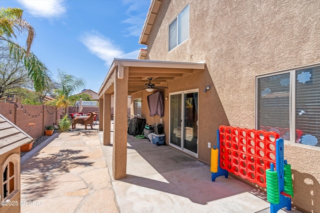 view of patio with a fenced backyard and ceiling fan