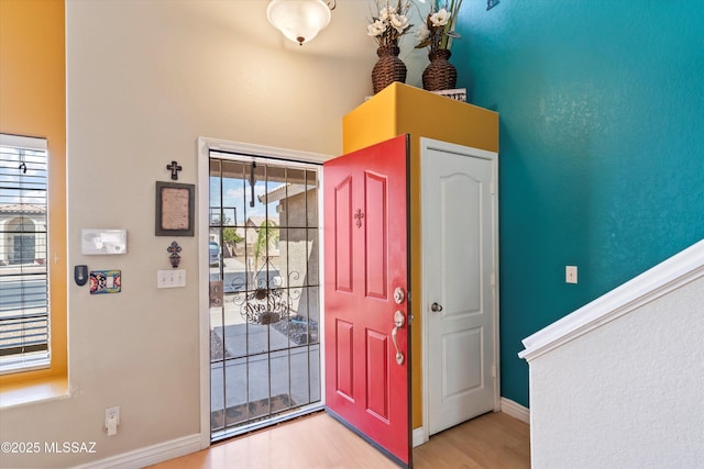 entryway featuring plenty of natural light, baseboards, and wood finished floors